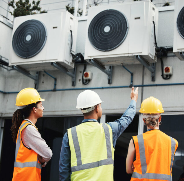 Building, looking and employees doing maintenance inspection on warehouse air together. Safety, eng.